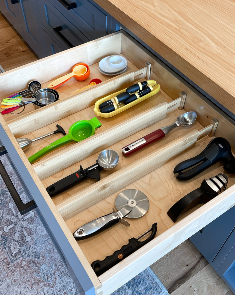 A kitchen drawer filled with utensils, and neatly organized with the Bamboo Deep Drawer Organizers - one of the best products from The Container Store.