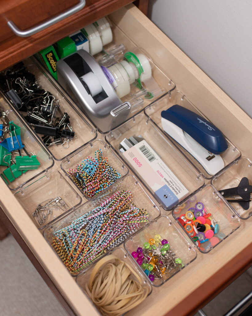 A drawer full of office supplies, organized with the Everything Organizer collection from The Container Store.