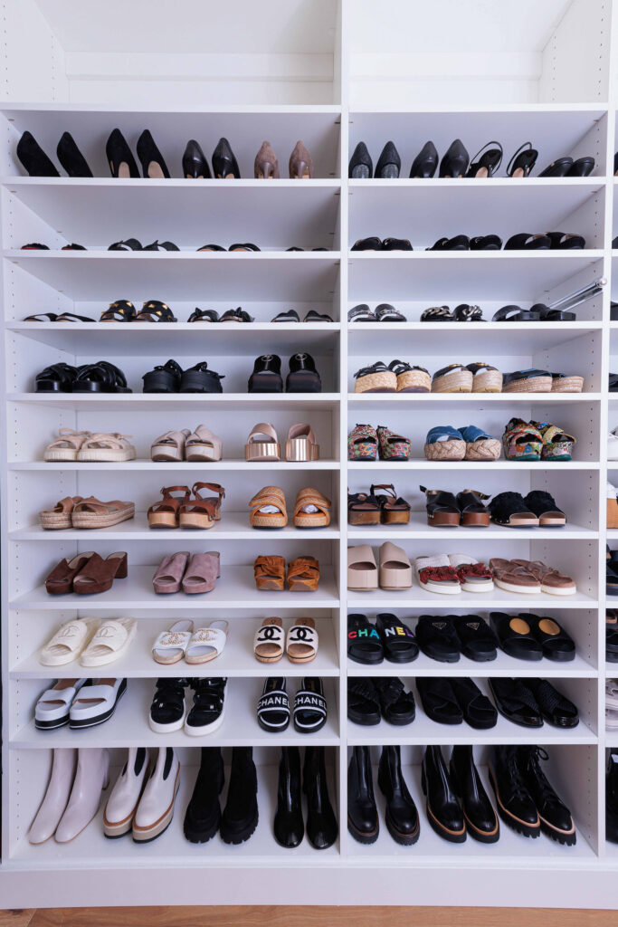 White closet shelves with perfectly organized shoes.