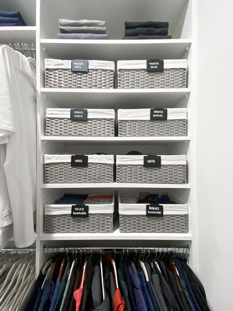 The Container Store Montauk bin baskets sitting on closet shelves with handwritten labels