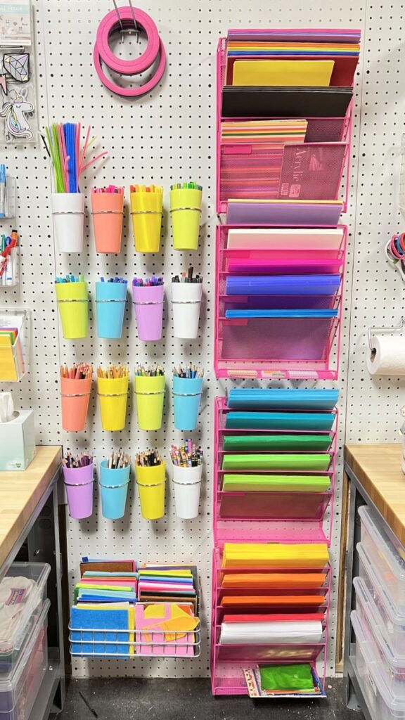 A large pegboard wall organizing craft and art supplies.  
