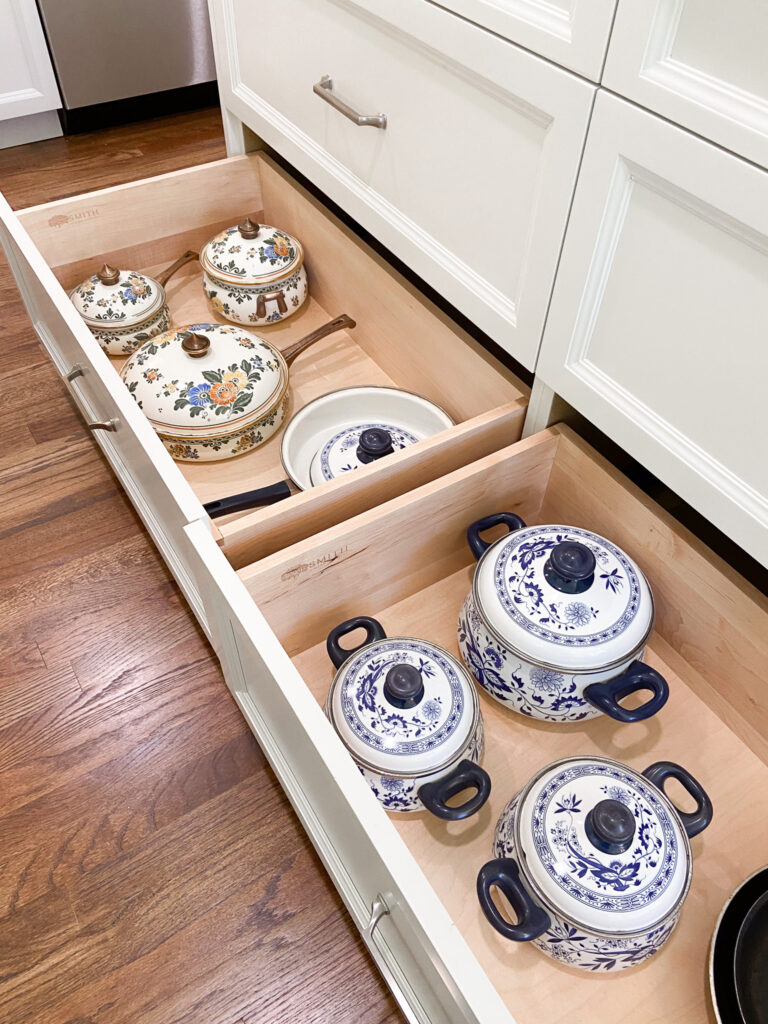 Decorative cookware organized in a kitchen drawer.