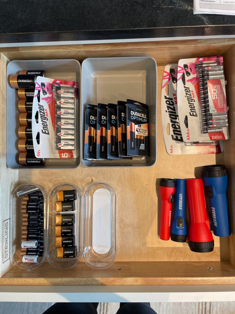 Unorganized, messy battery drawer.
