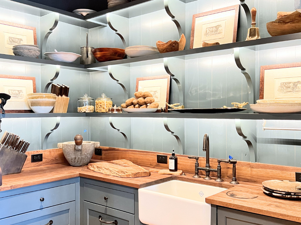 A butler's pantry with wooden countertops and blue cabinets. 