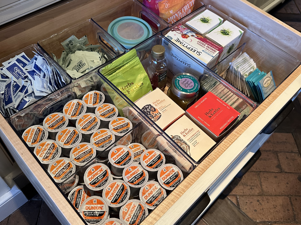 Coffee and tea drawer open showing perfectly organized items from UpTown Concierge